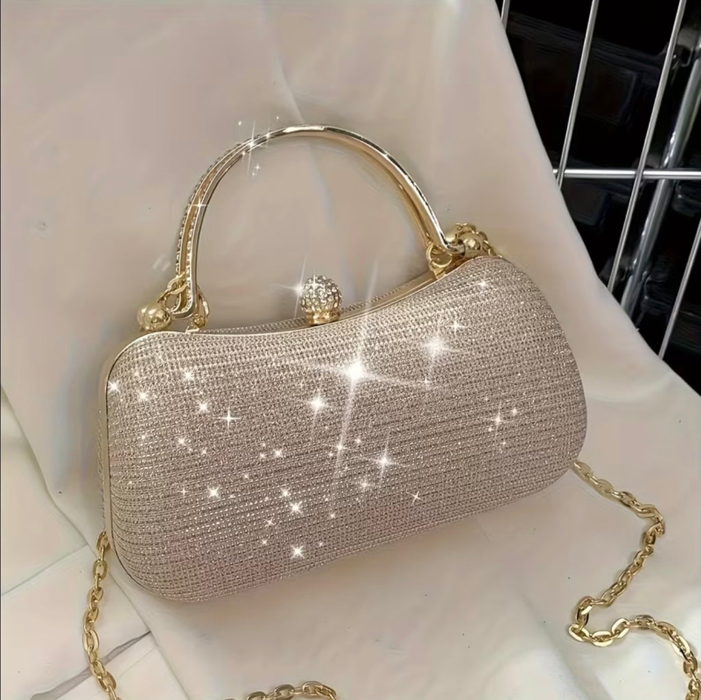 Champagne glitter clutch bag on a chair